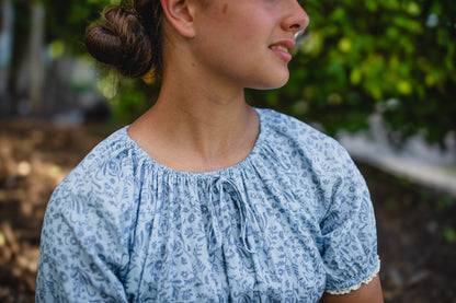 woman in a modest blue nursing dress