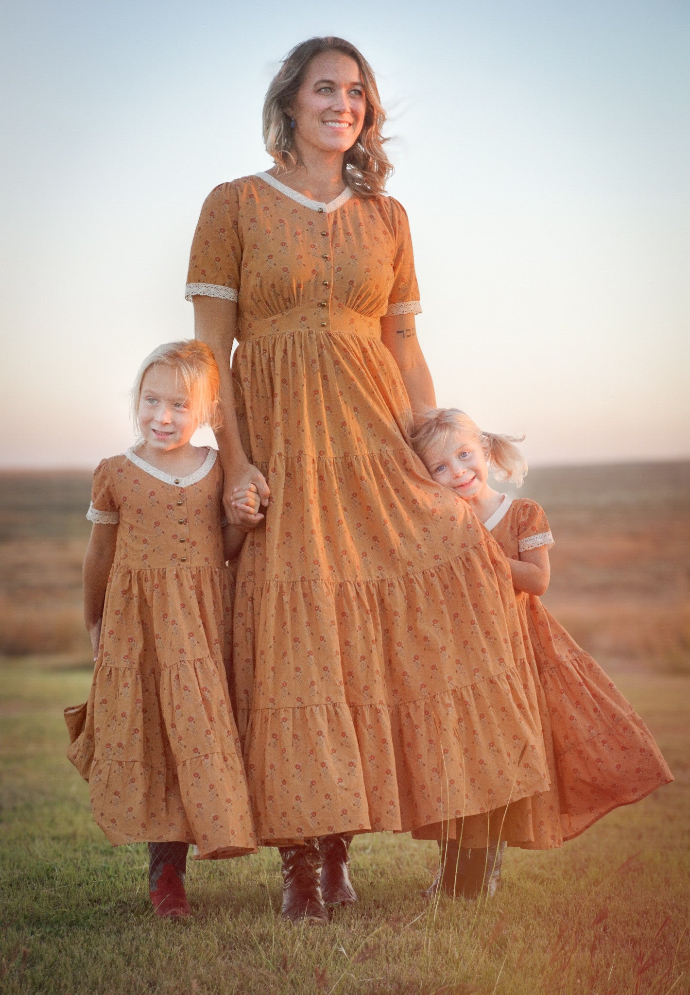 Woman in modest nursing dress with two children in matching dresses