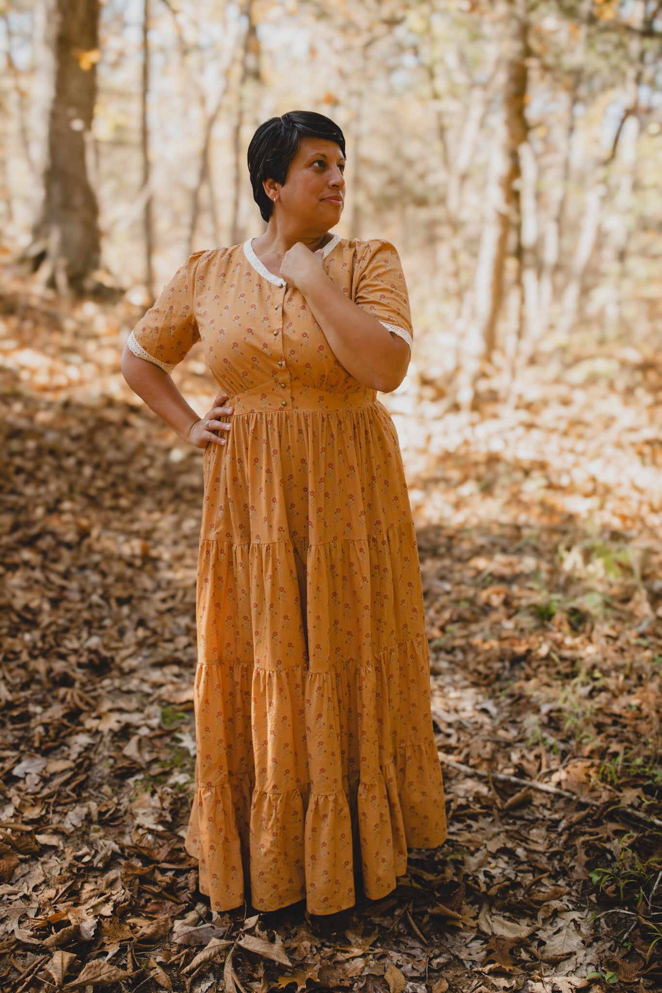 Woman in modest nursing dress forest fallen leaves