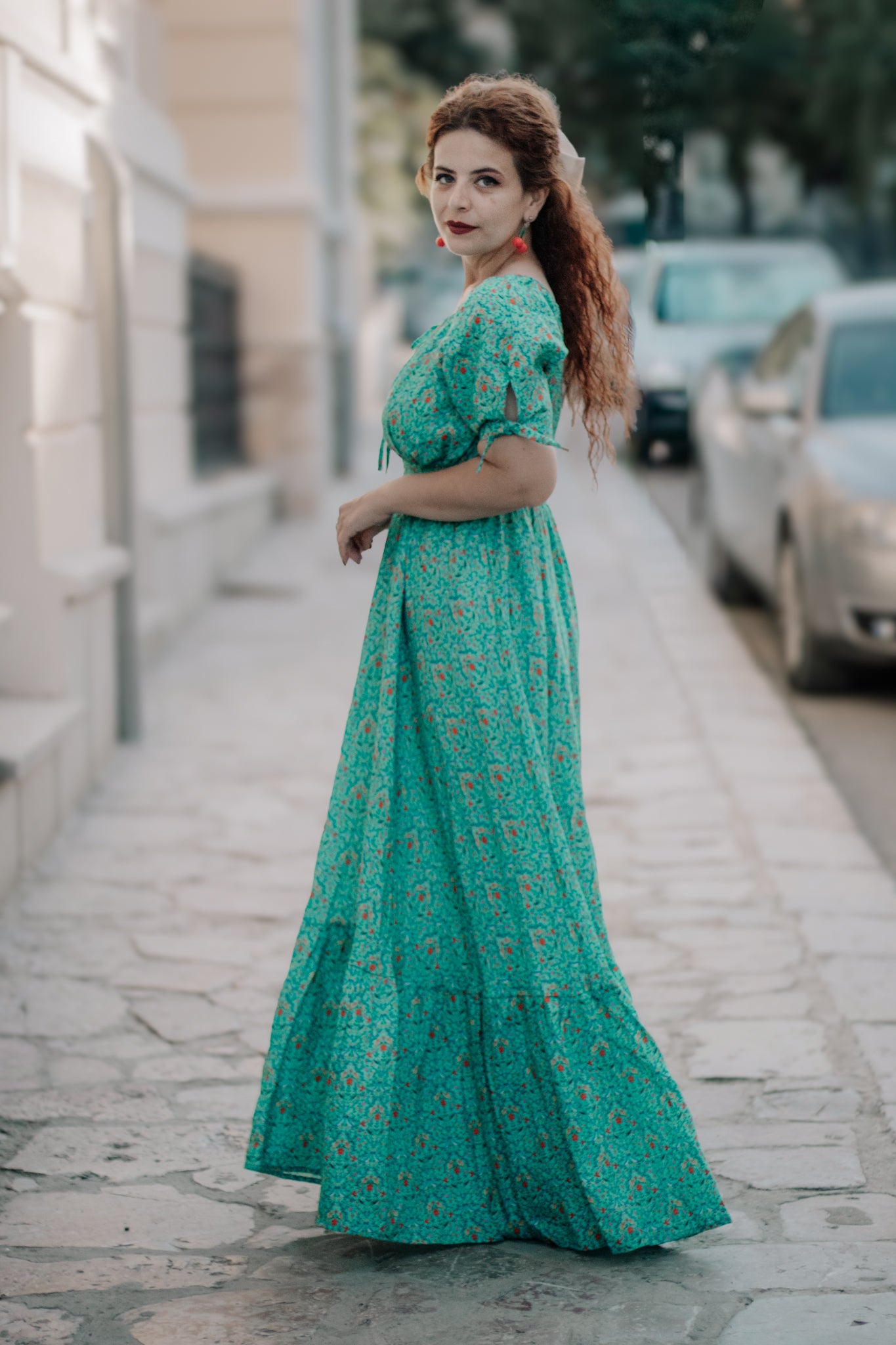 Woman in modest nursing green patterned dress