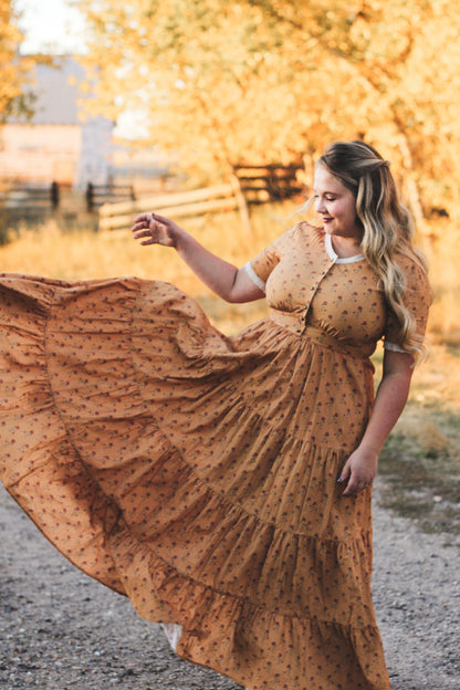 Woman in modest nursing dress yellow field