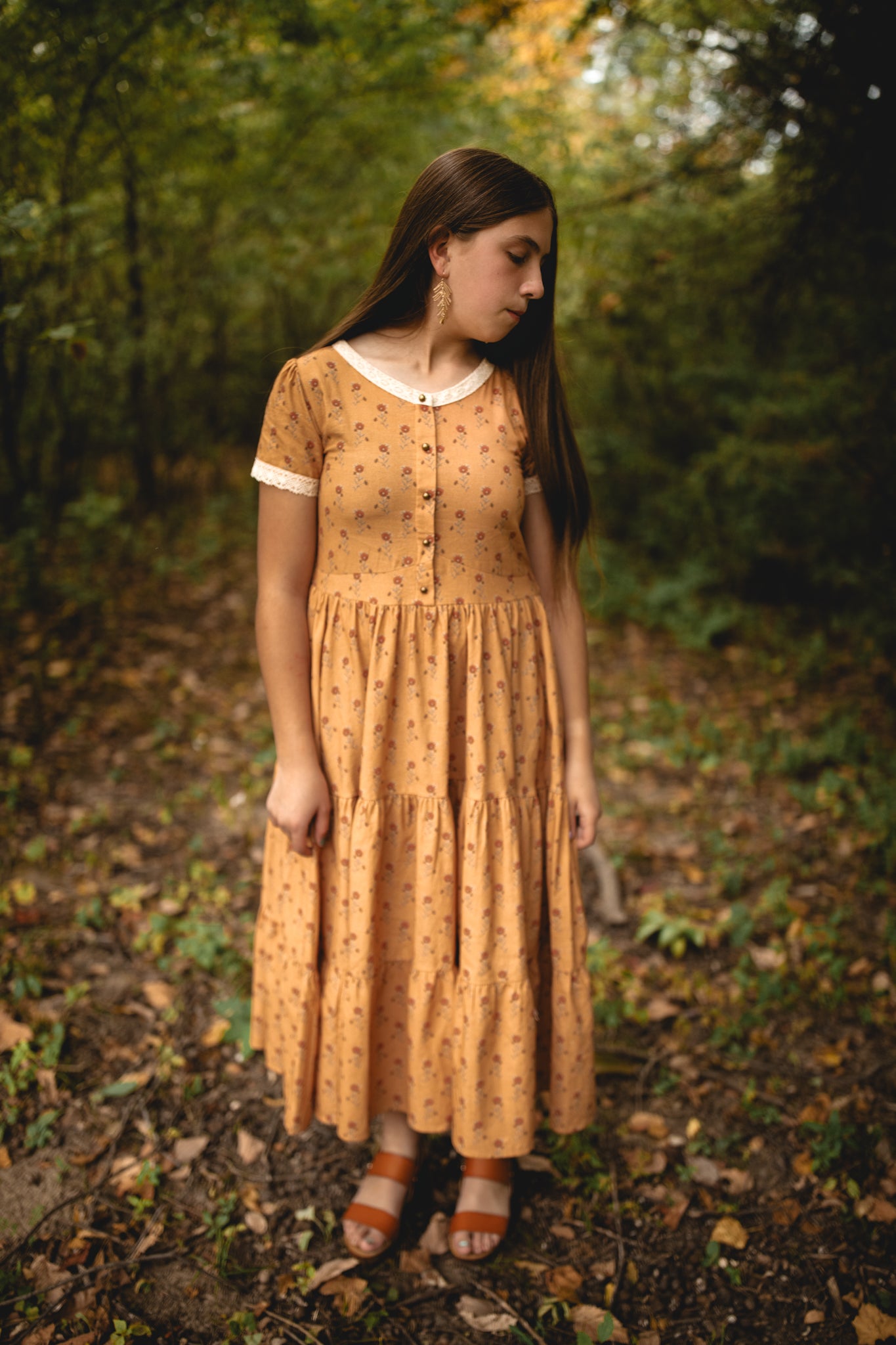 Woman in modest nursing dress in forest