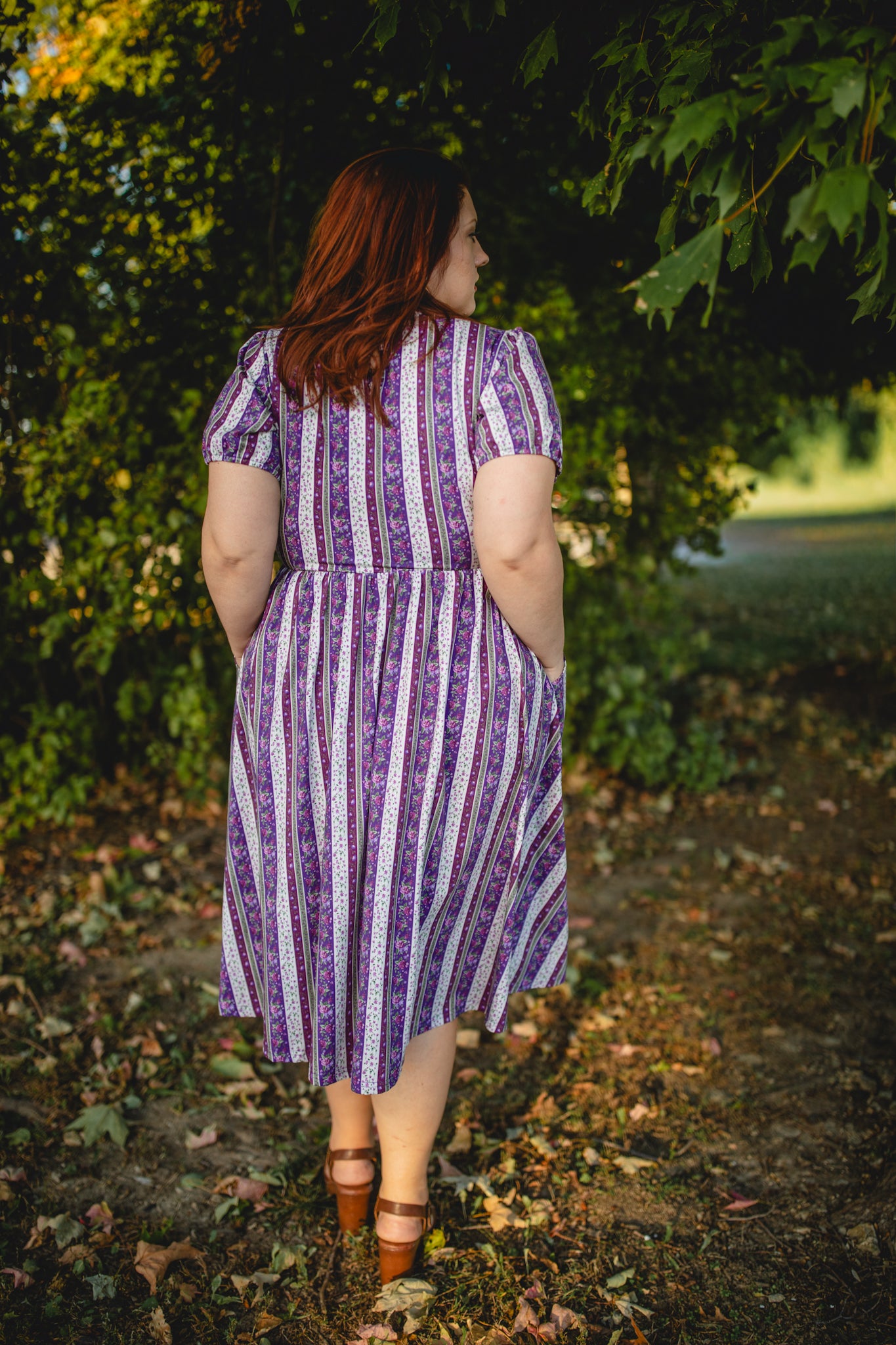 woman wearing a modest nursing purple and white striped dress