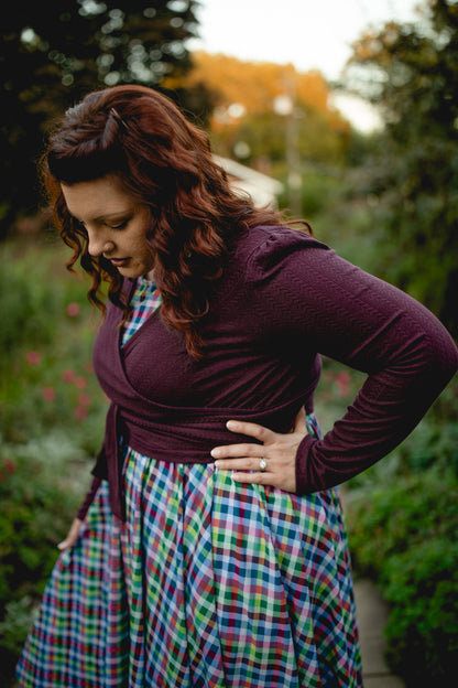Woman in modest nursing wrap and plaid skirt