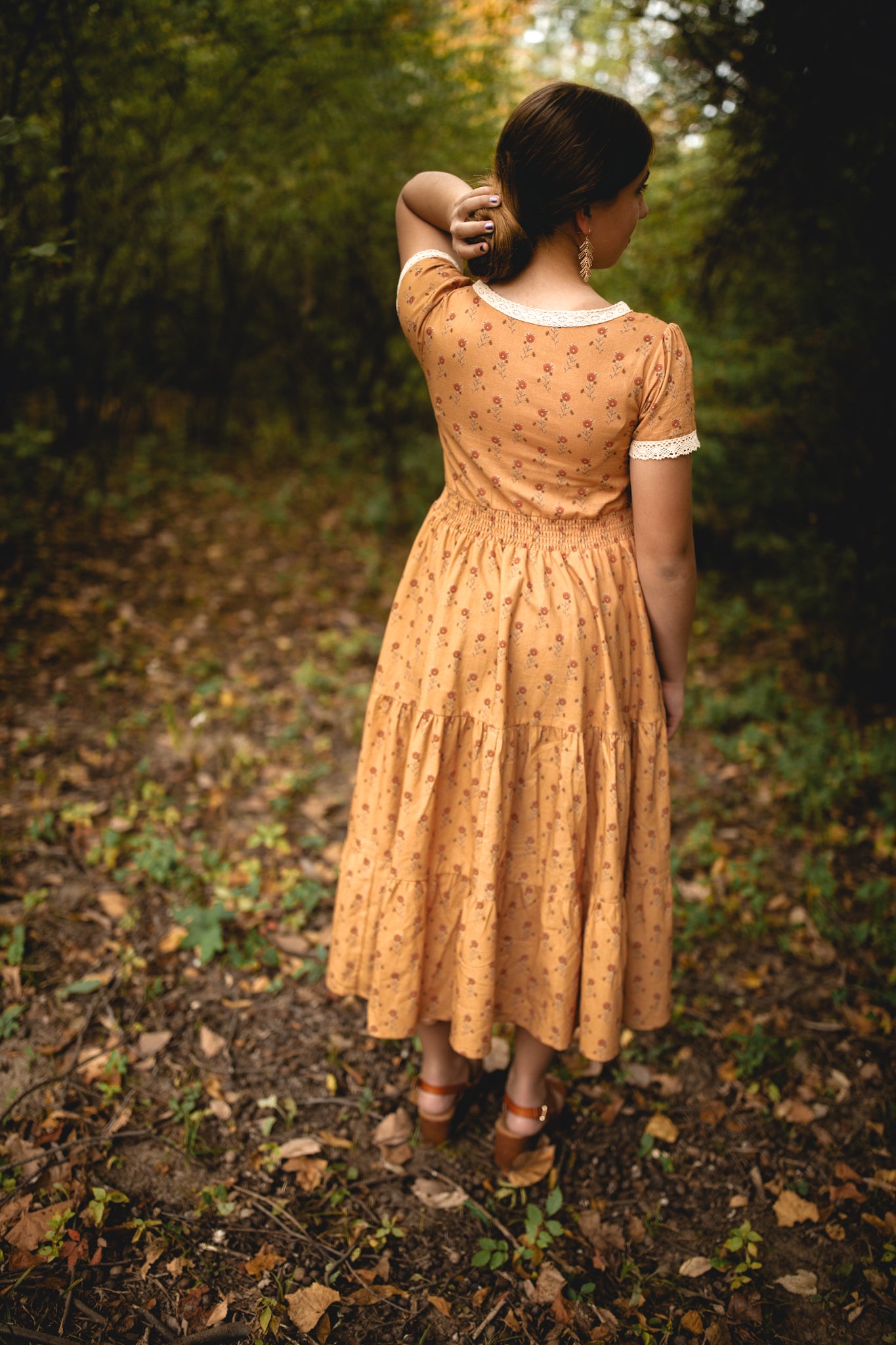 Woman in modest nursing dress in forest