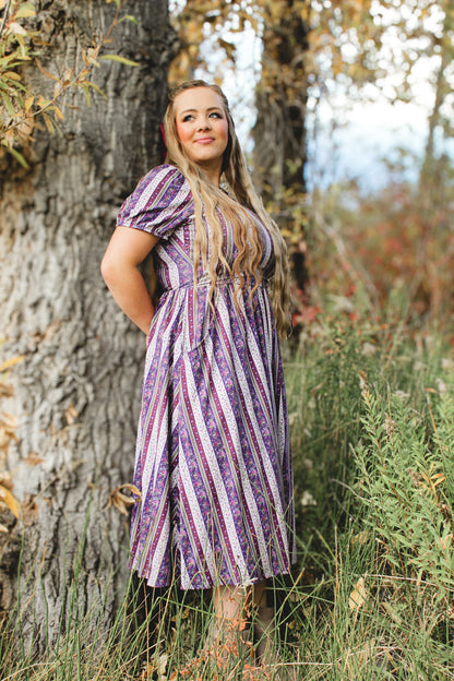 woman wearing a modest nursing purple and white striped dress