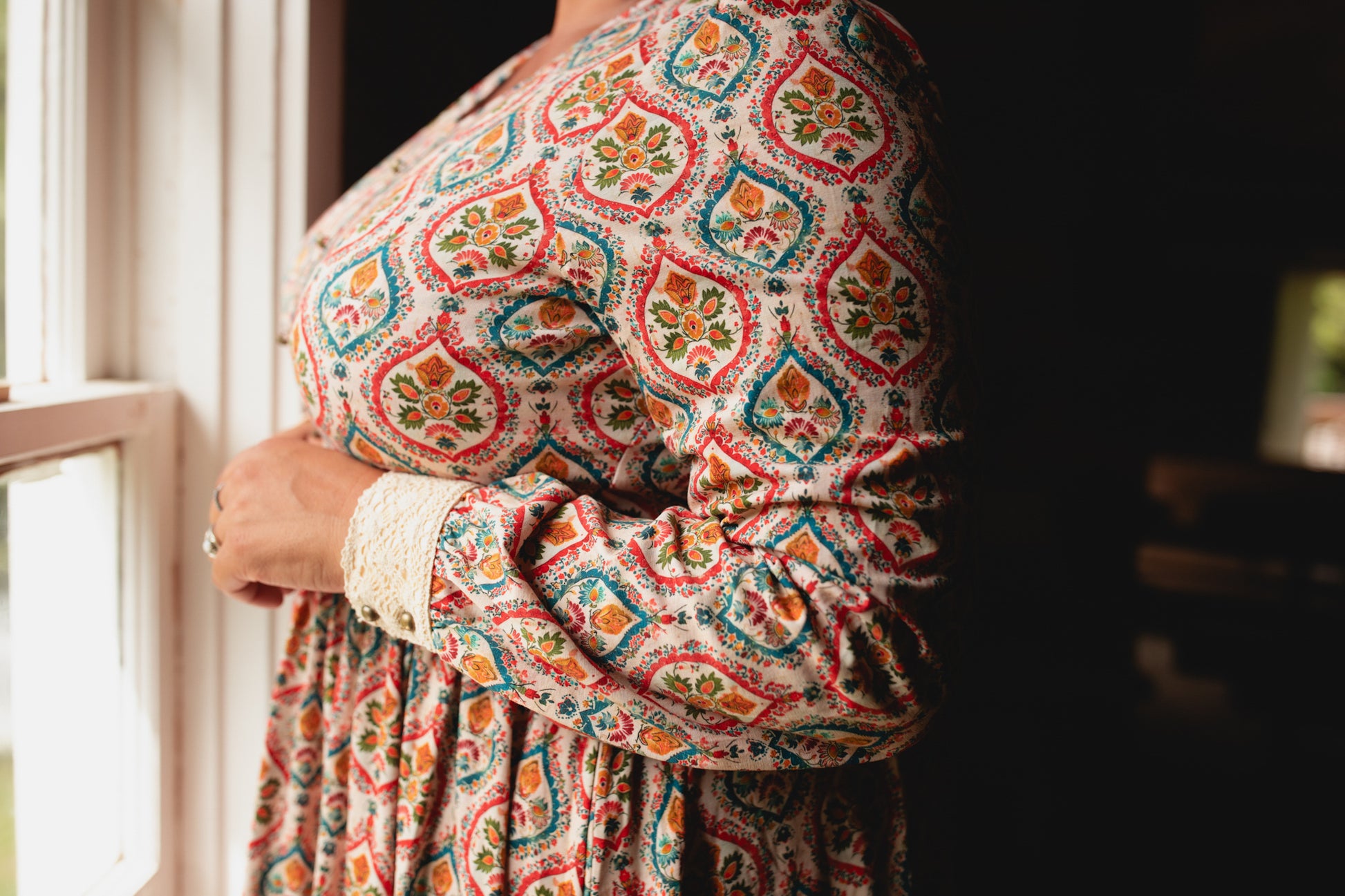 Woman wearing a patterned modest nursing dress