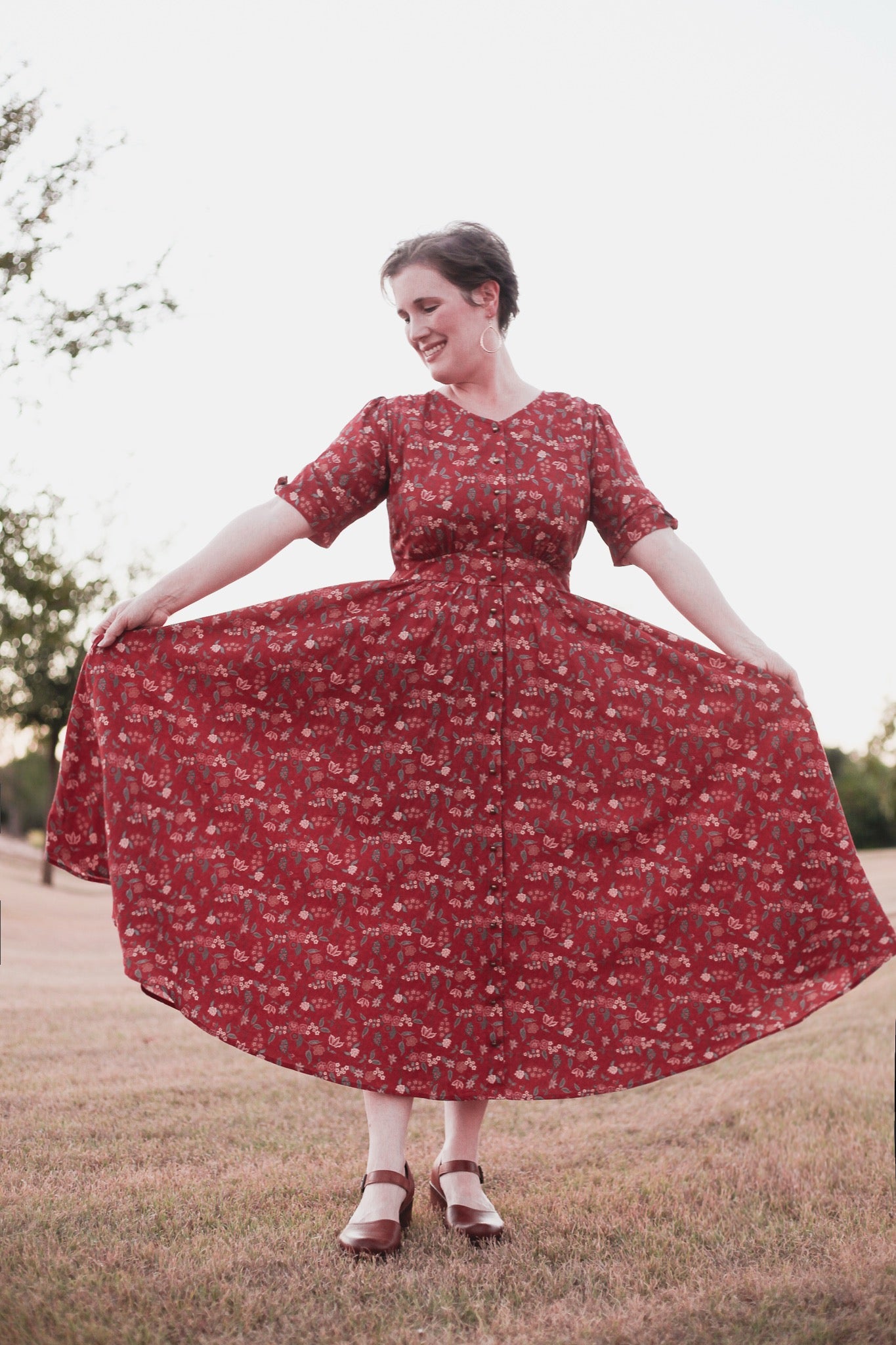 Woman in modest nursing red floral dress outdoors
