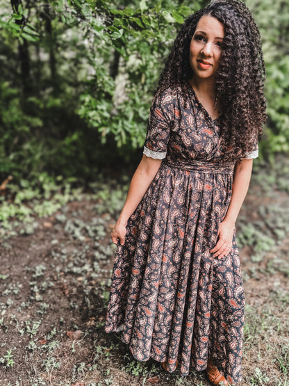 Woman in modest nursing dress in forest setting