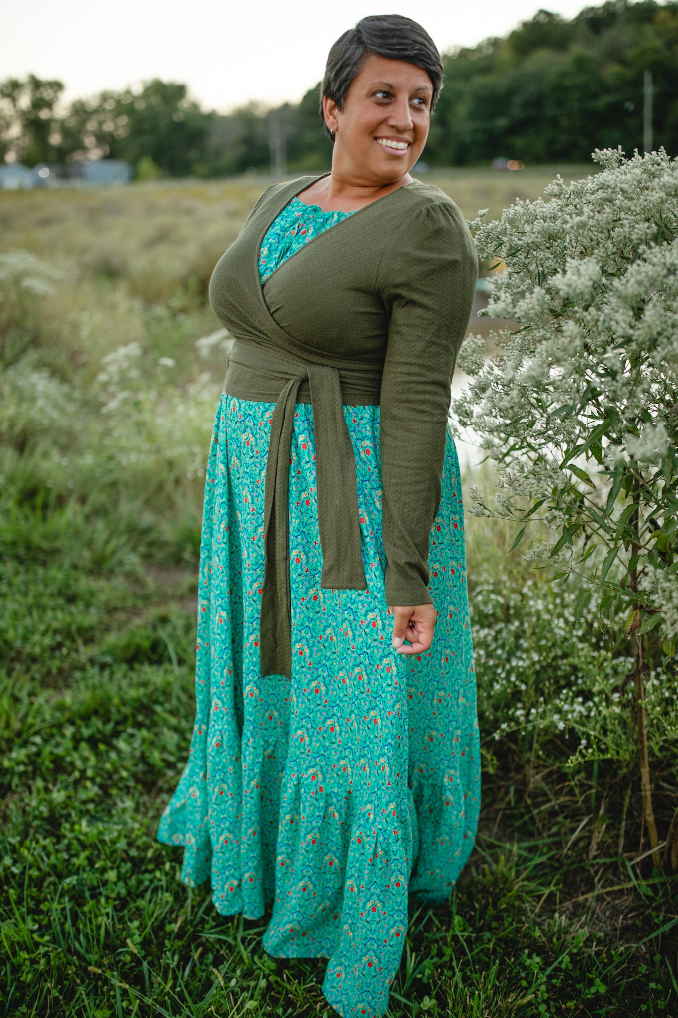 Woman in modest nursing green dress standing