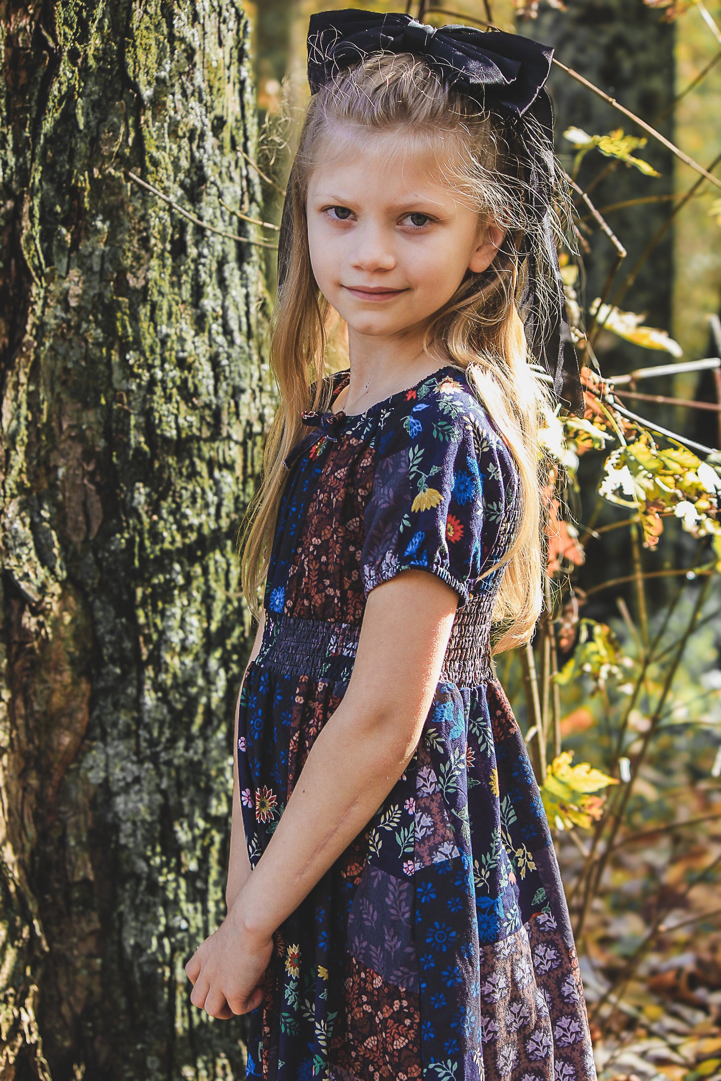young girl wearing a cute patchwork dress