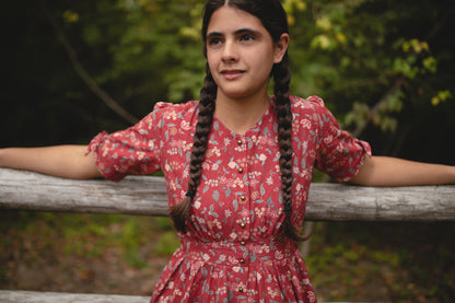Young girl in modest red floral dress outdoors