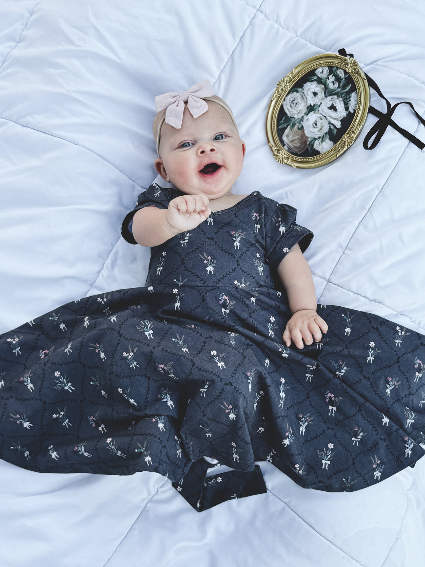 Modest baby in dark blue floral dress