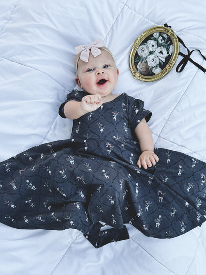 Modest baby in dark blue floral dress
