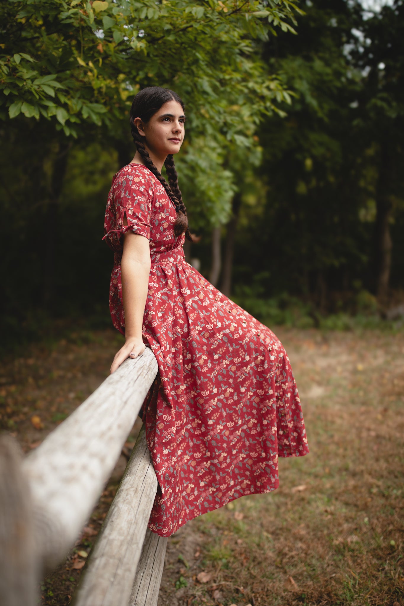 Woman in modest nursing red floral dress outdoors