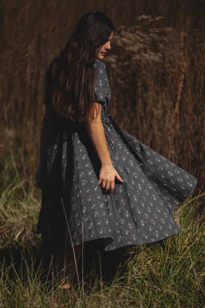 Modest nursing-friendly dark dress in field