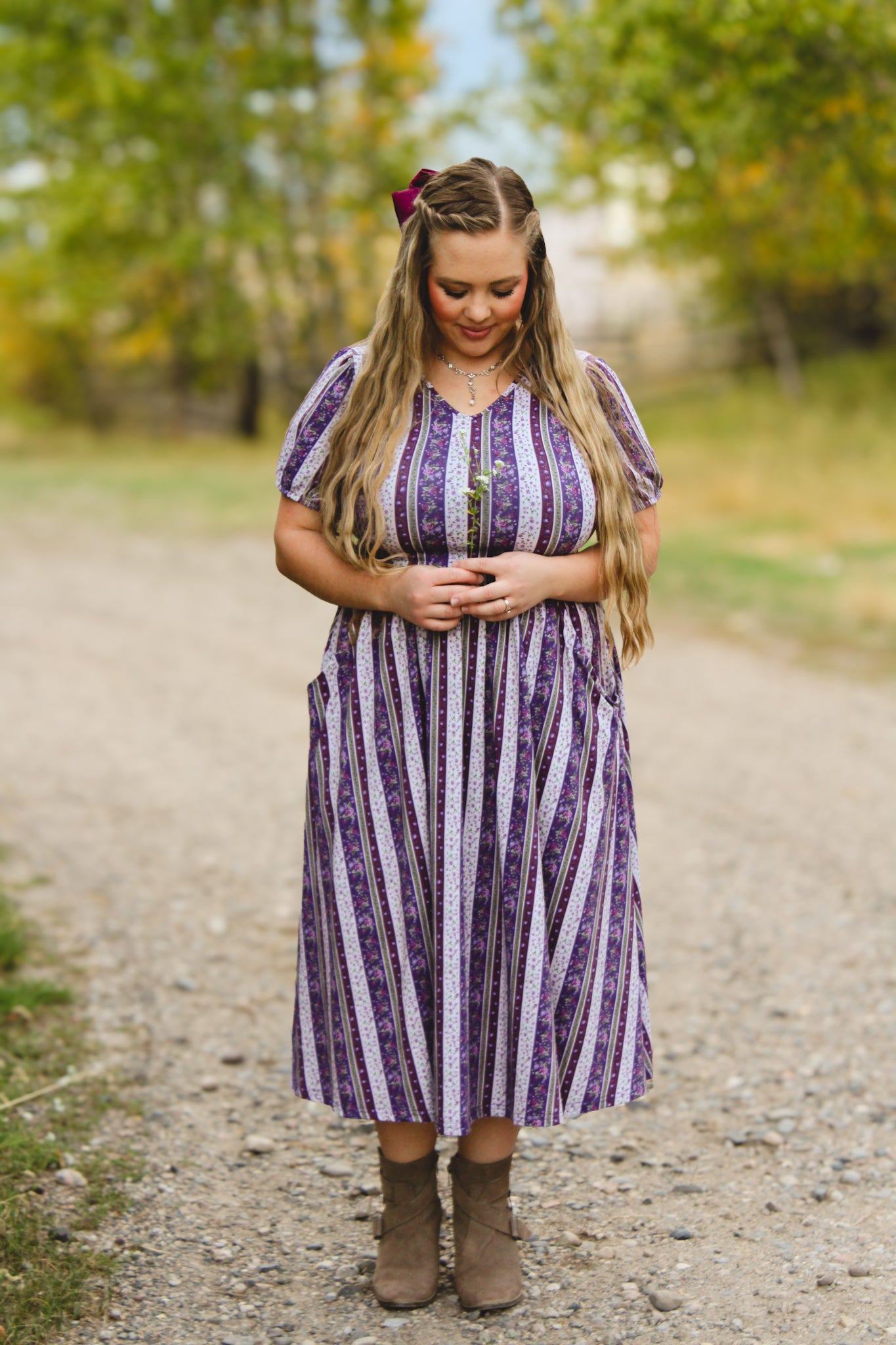 woman wearing a modest nursing purple and white striped dress