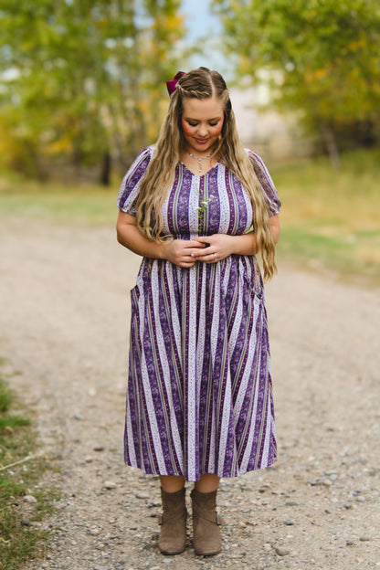 woman wearing a modest nursing purple and white striped dress