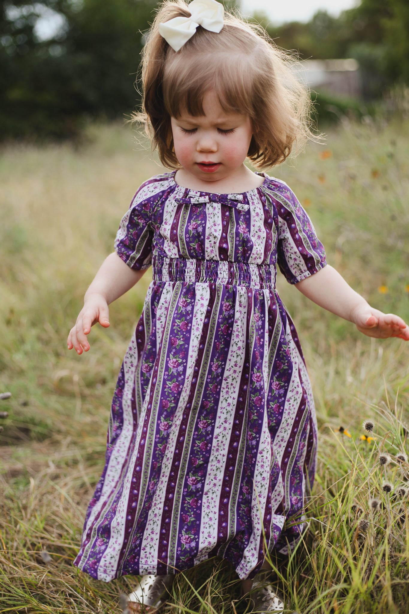 Child in modest purple patterned dress