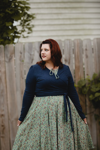 Woman in modest nursing-friendly blue top and floral skirt
