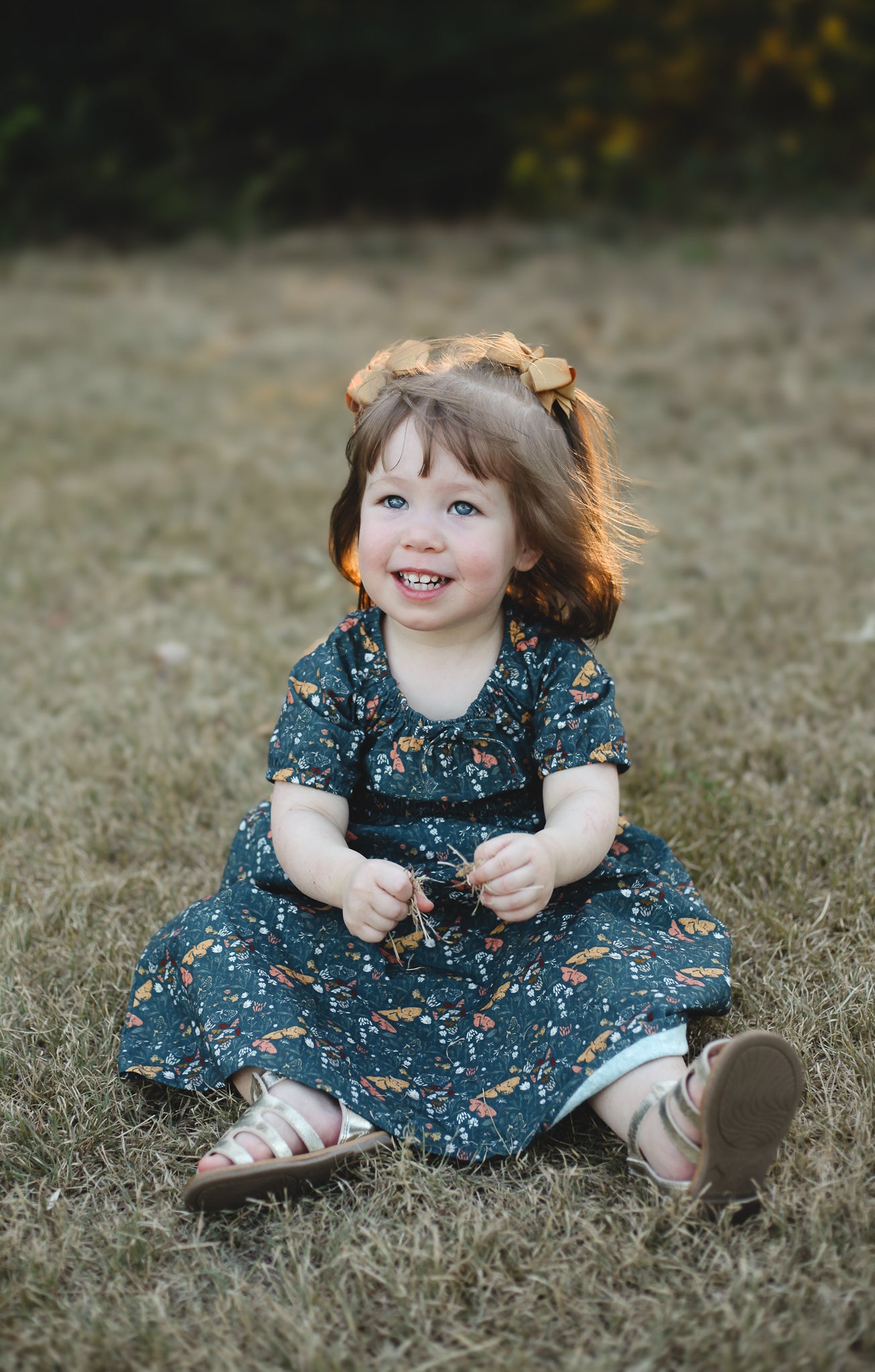 Girl in modest floral dress sitting