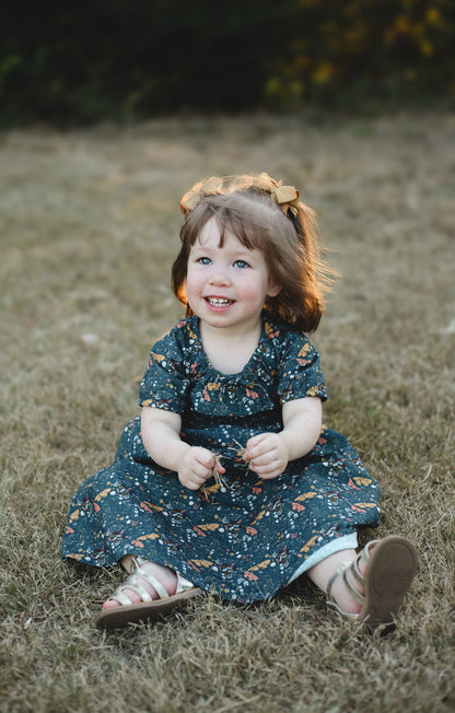 Girl in modest floral dress sitting