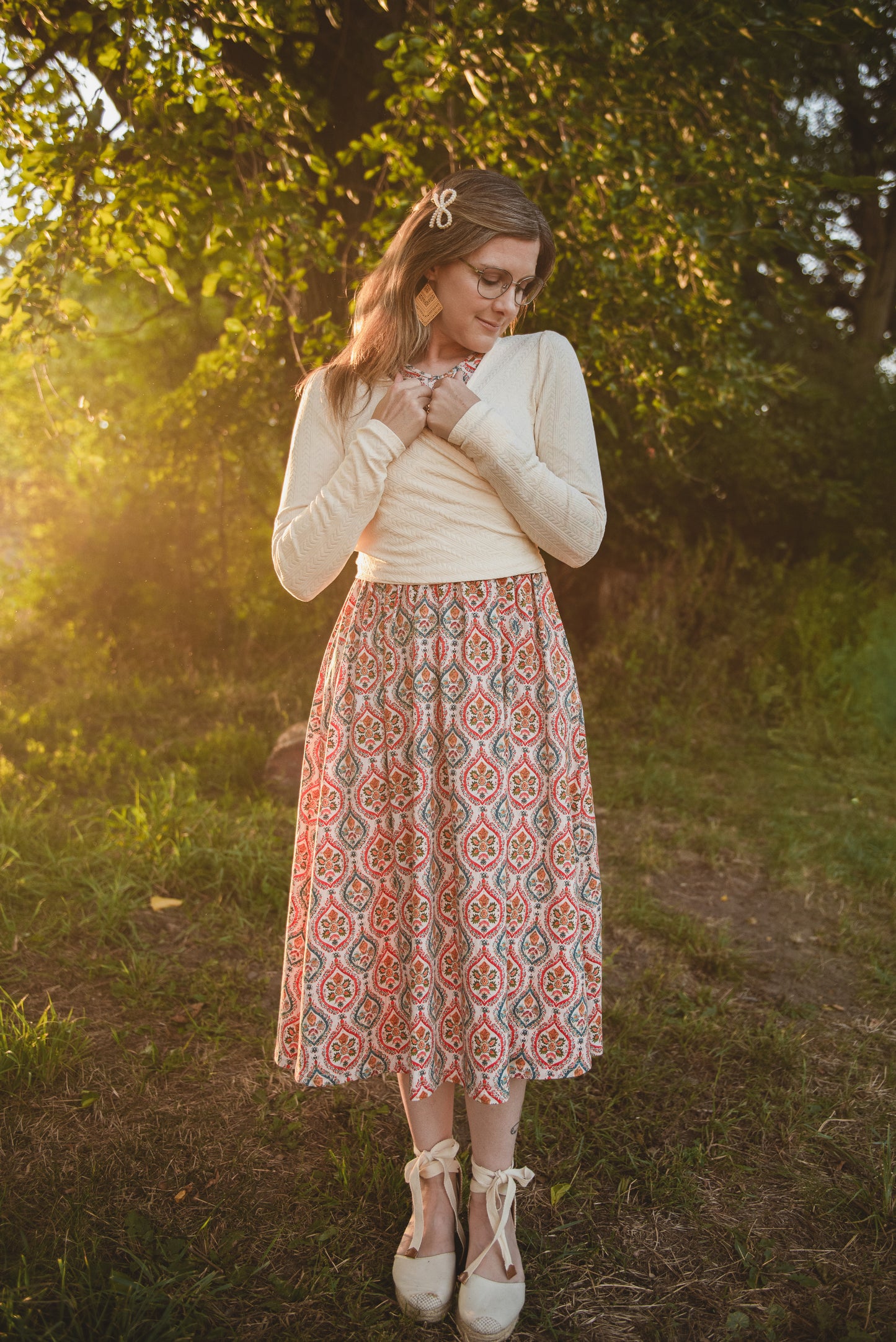Woman in modest nursing outfit in sunlit forest