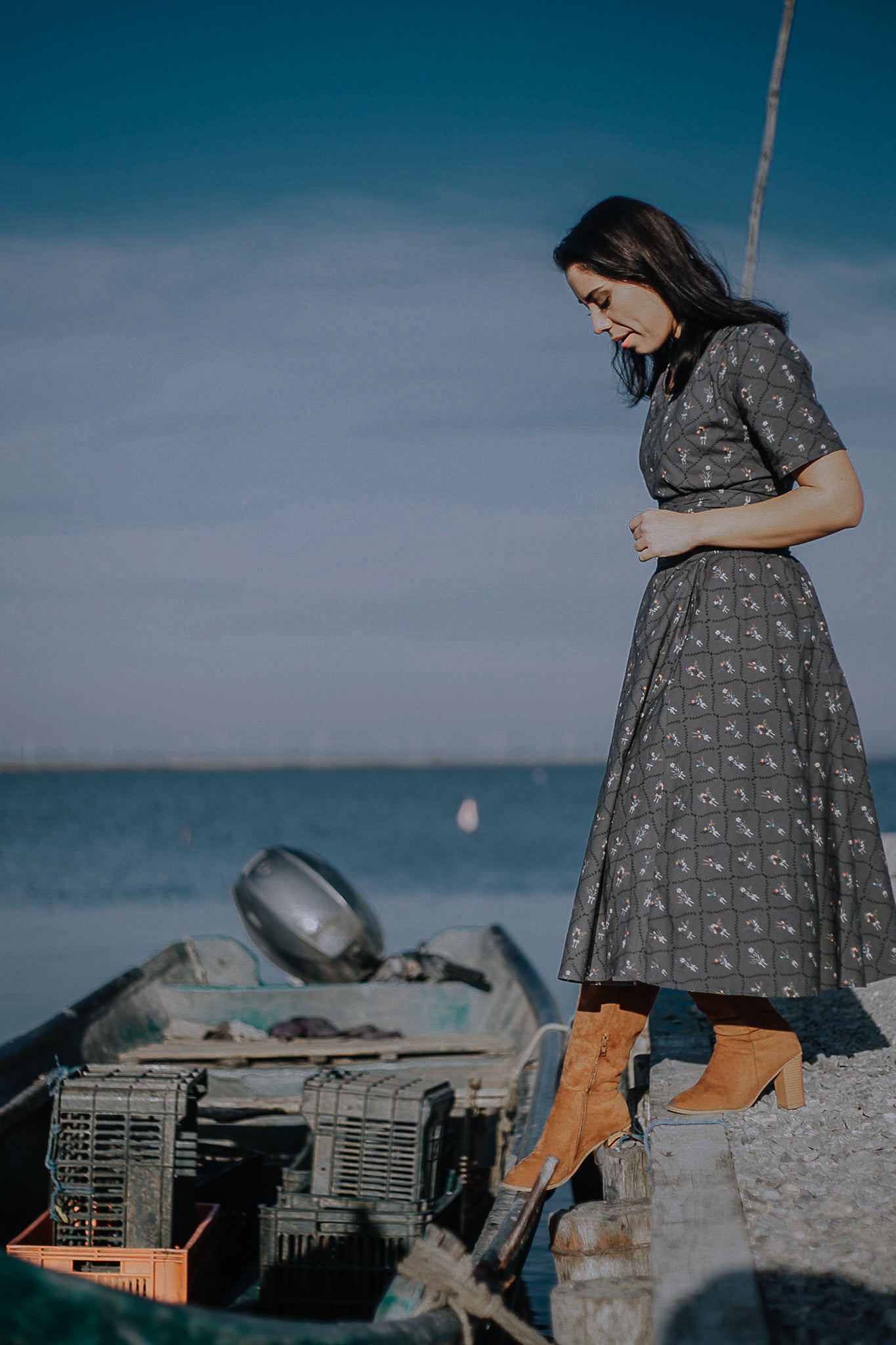 Modest nursing-friendly gray patterned dress on boat