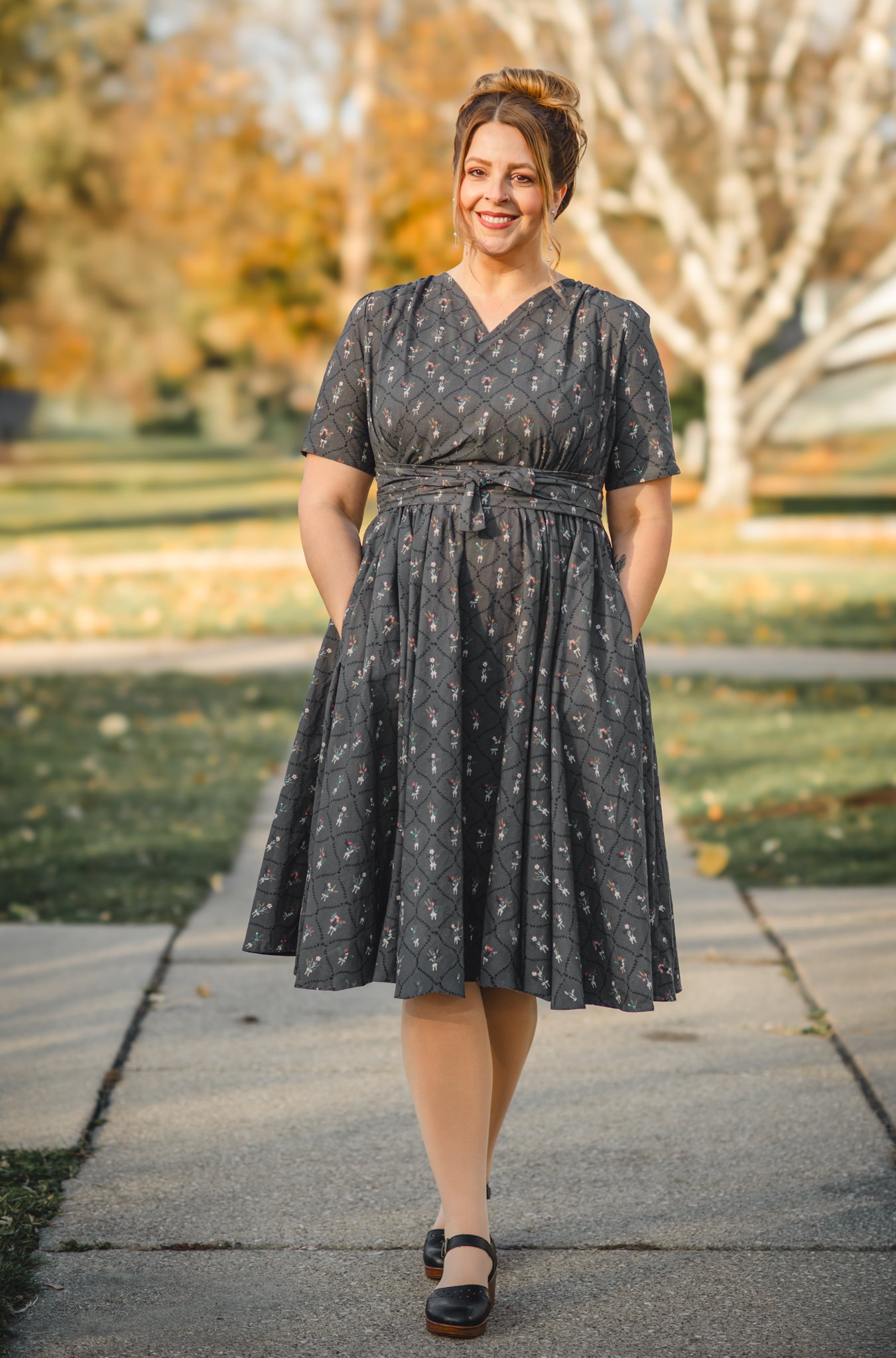 Modest nursing-friendly dark patterned dress outdoors