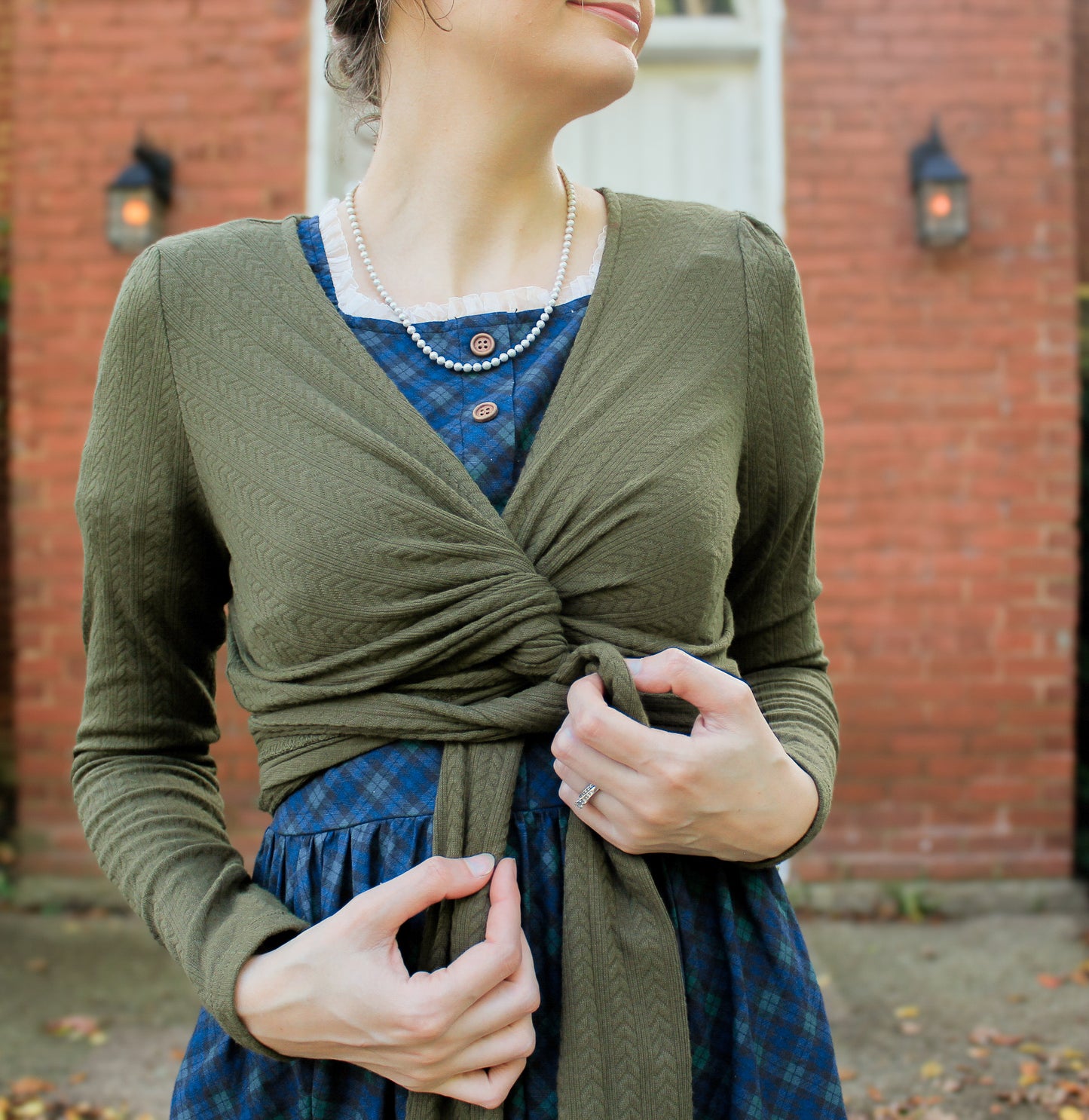 Woman in modest nursing wrap over dress