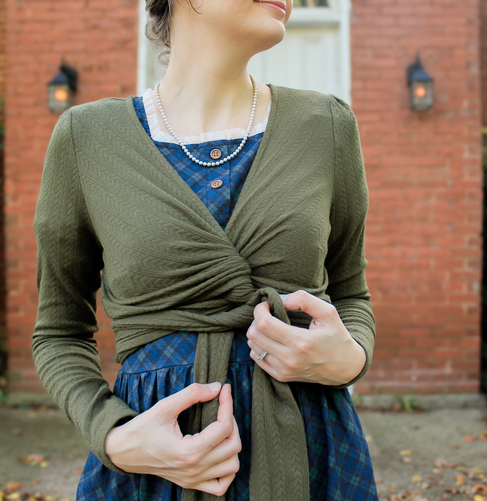 Woman in modest nursing wrap over dress