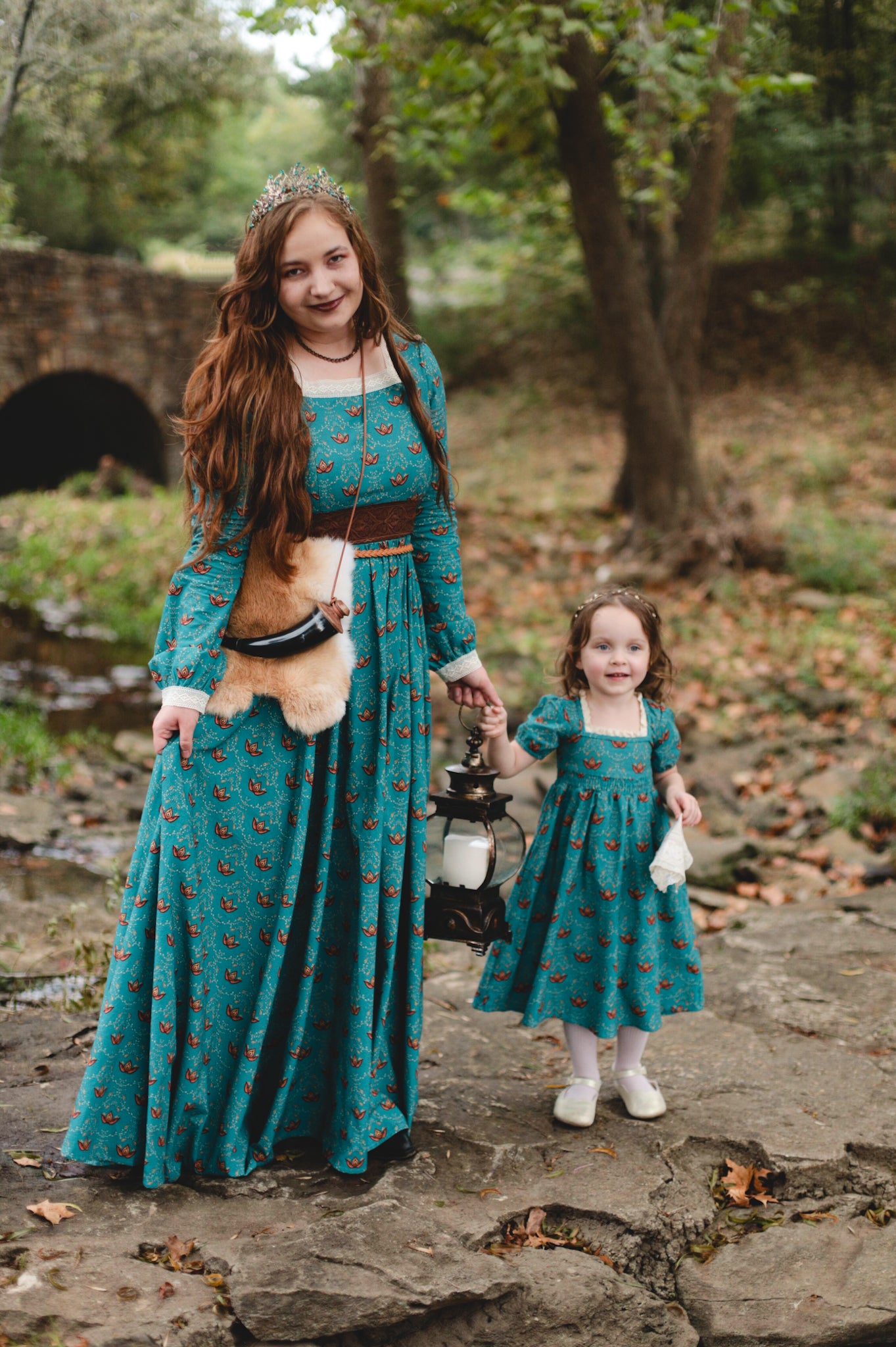 Two women in modest nursing teal dresses outdoors