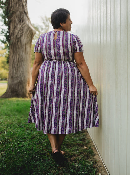 woman wearing a modest nursing purple and white striped dress