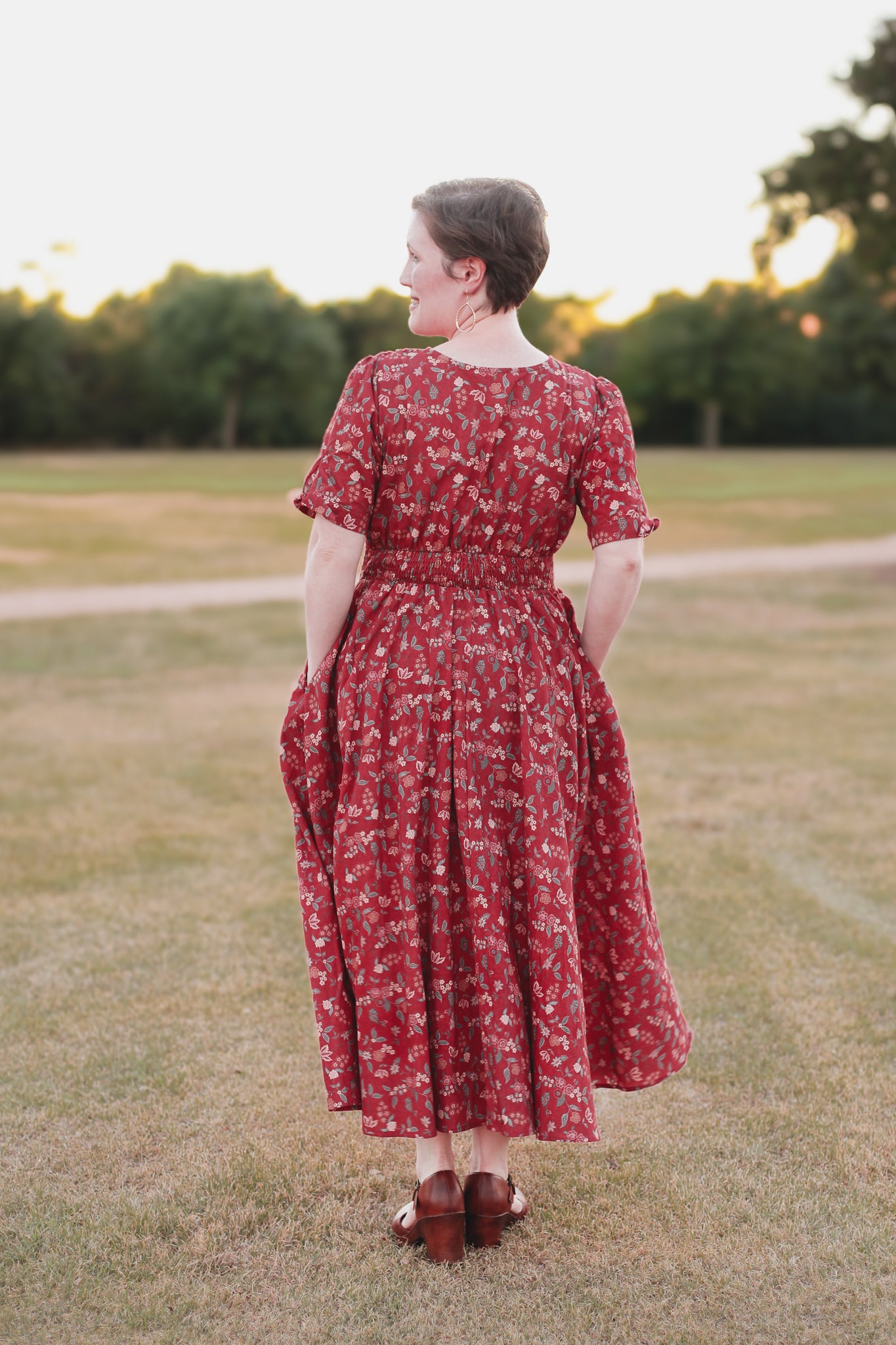 Woman in modest nursing red floral dress outdoors