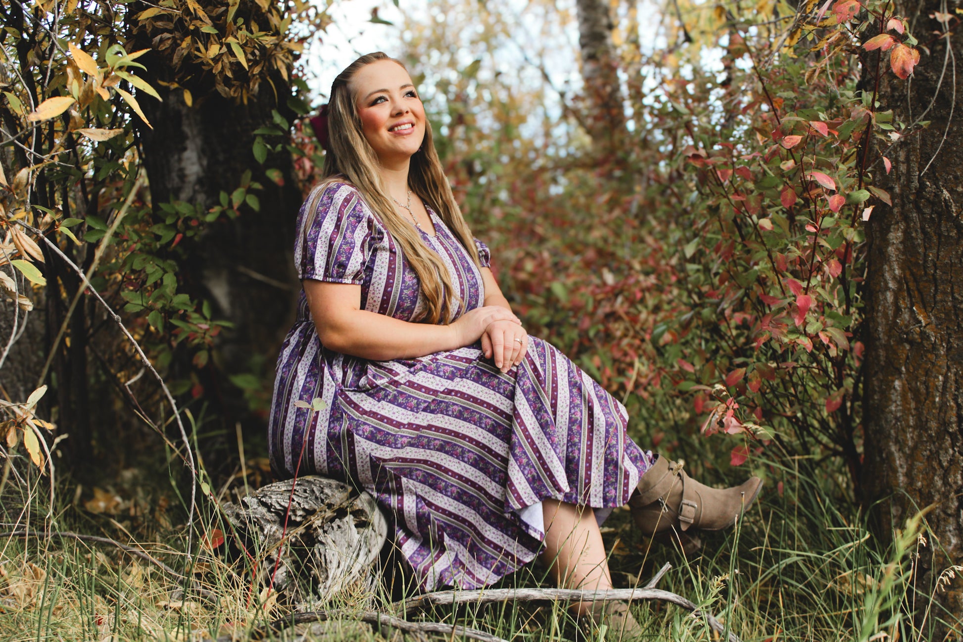 woman wearing a modest nursing purple and white striped dress