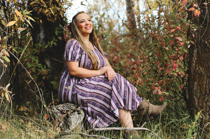 woman wearing a modest nursing purple and white striped dress