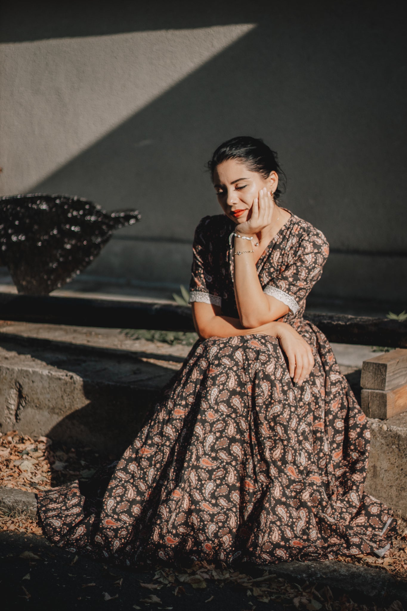 Woman in modest nursing dress sitting on steps