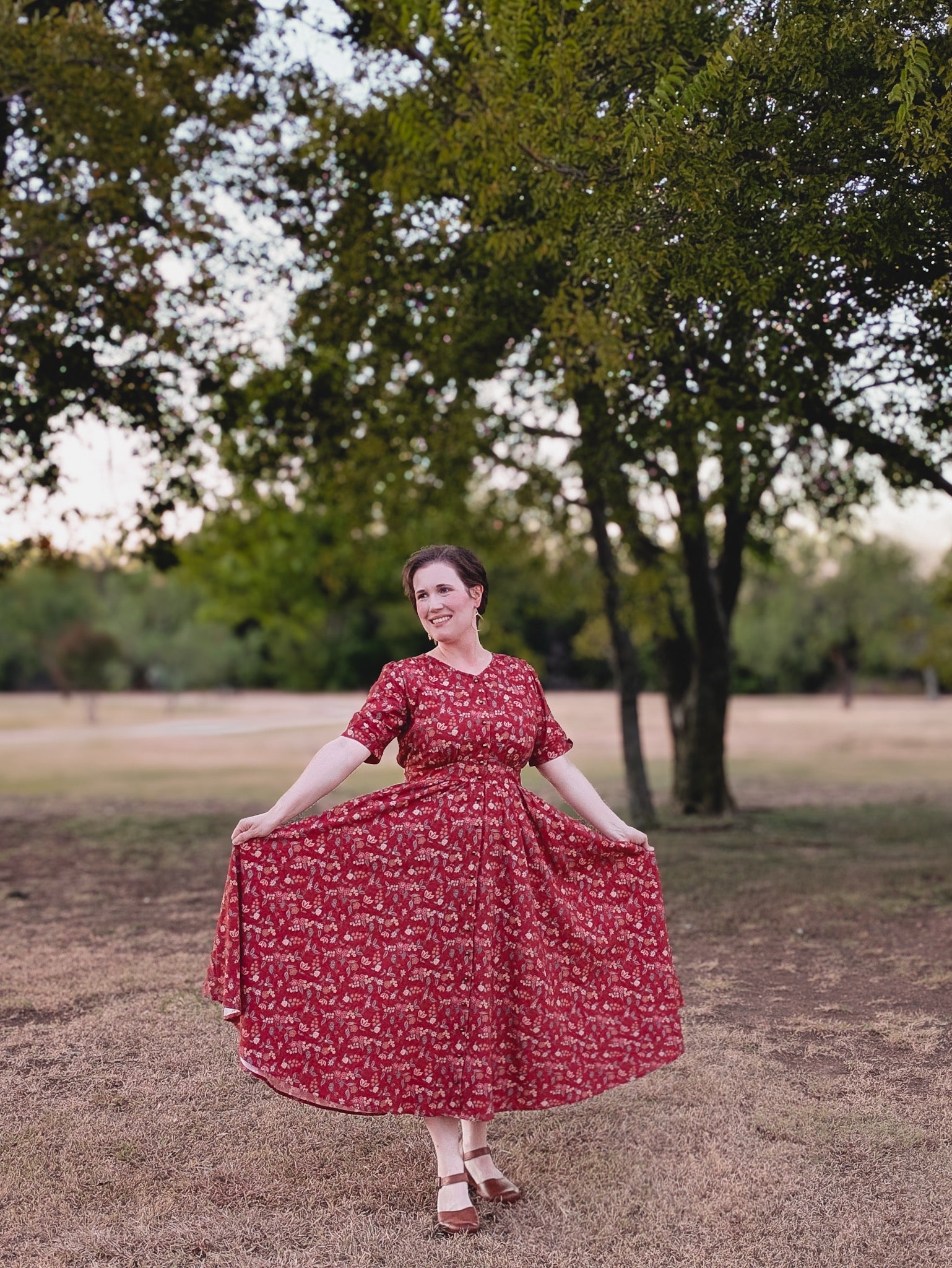 Woman in modest nursing red floral dress outdoors