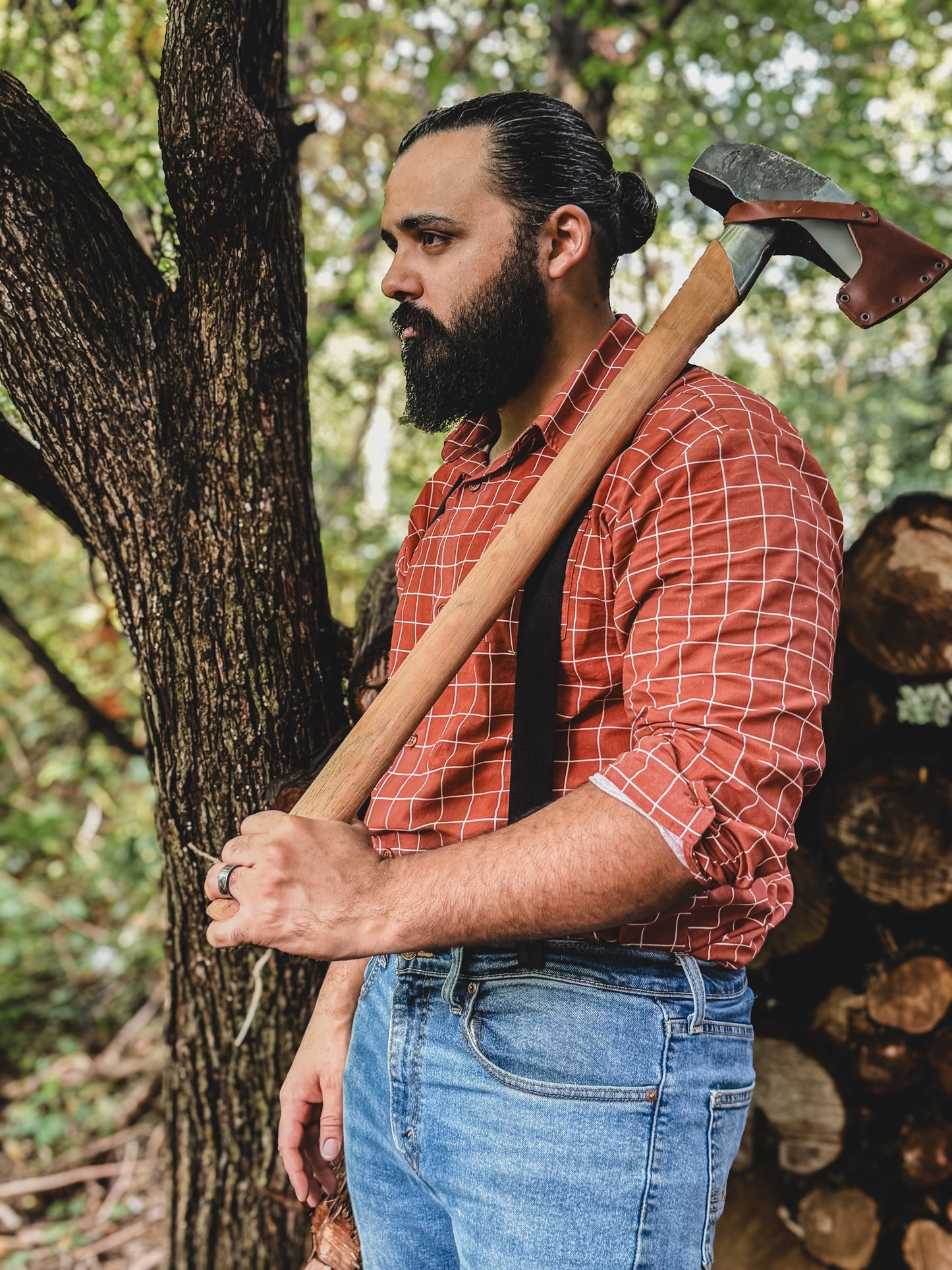 Man holding an axe in a forest setting