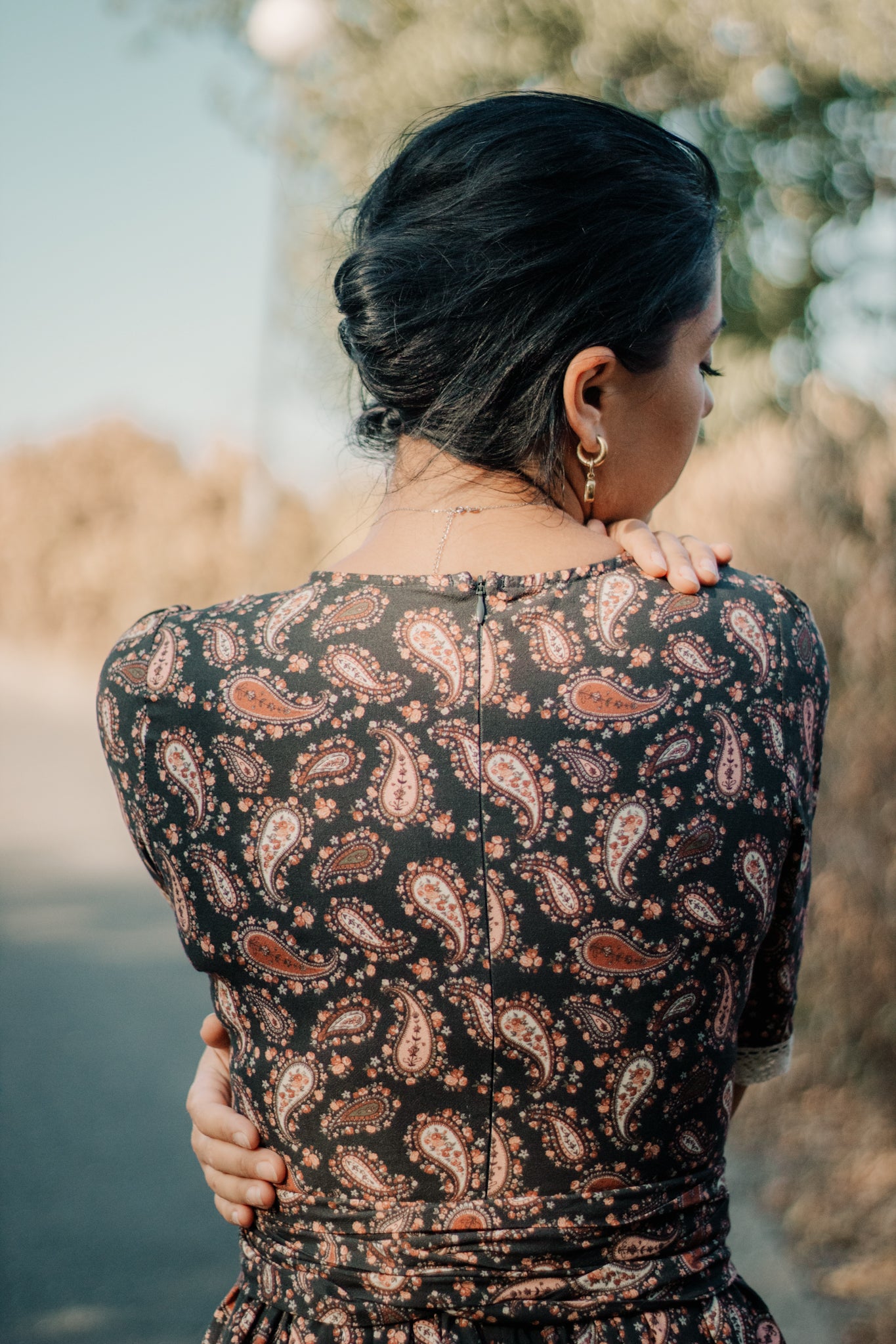 woman wearing a modest nursing black patterned dress