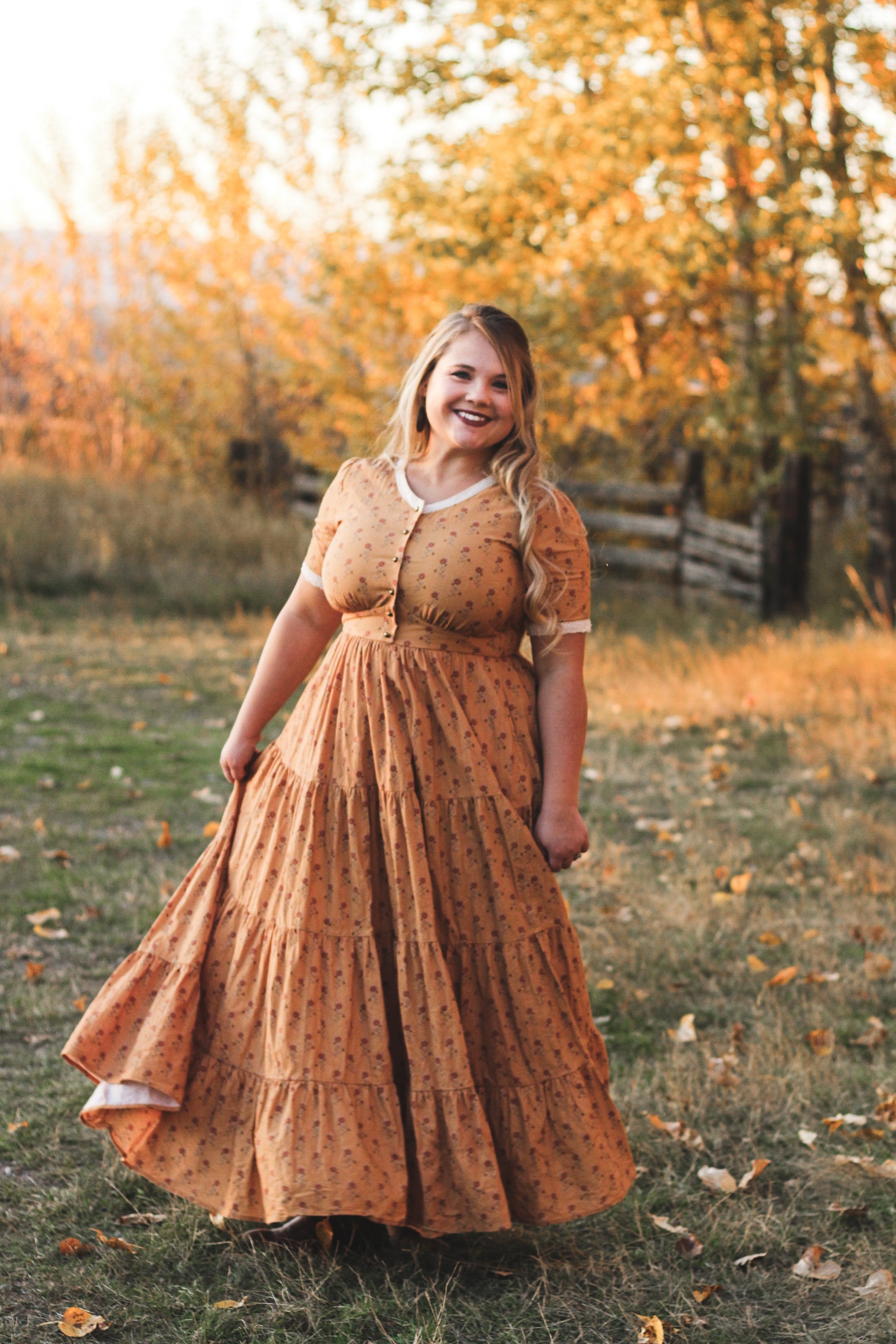 Woman in modest nursing dress autumn field