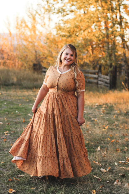 Woman in modest nursing dress autumn field