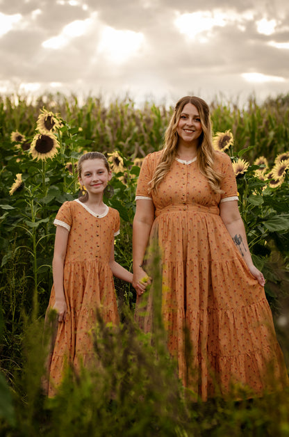 Two women in modest nursing dresses in field