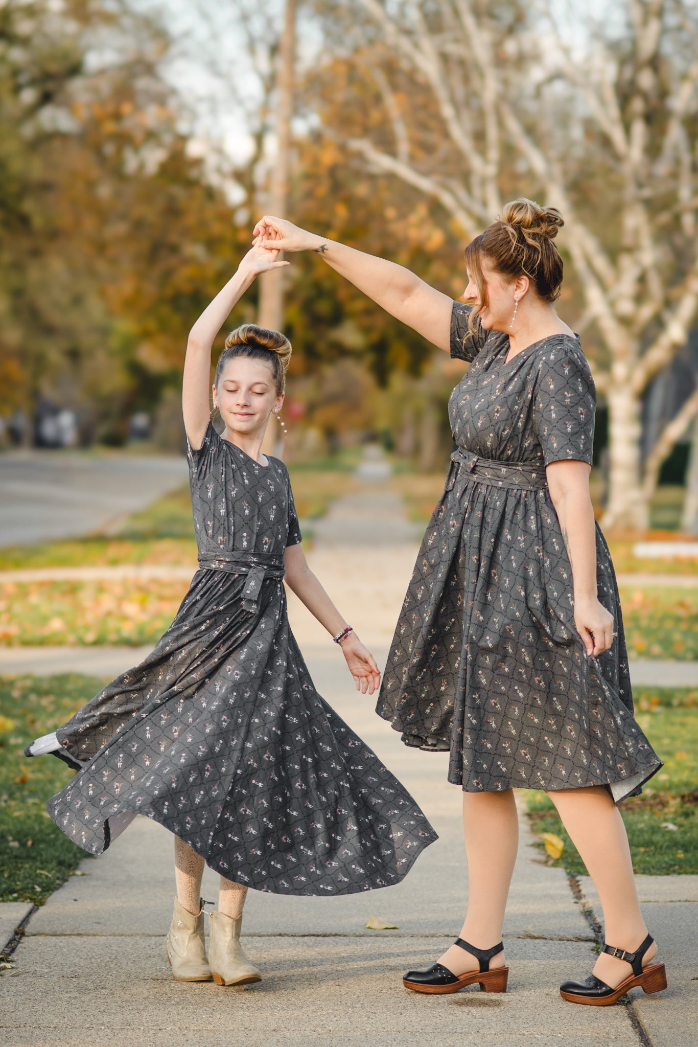 Modest nursing dress woman with modest child dancing