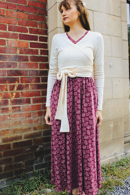 Woman in modest nursing outfit against brick wall
