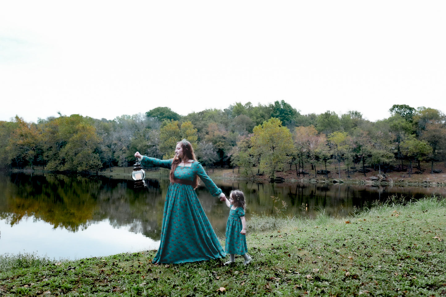 Woman in modest nursing teal dress with child by lake
