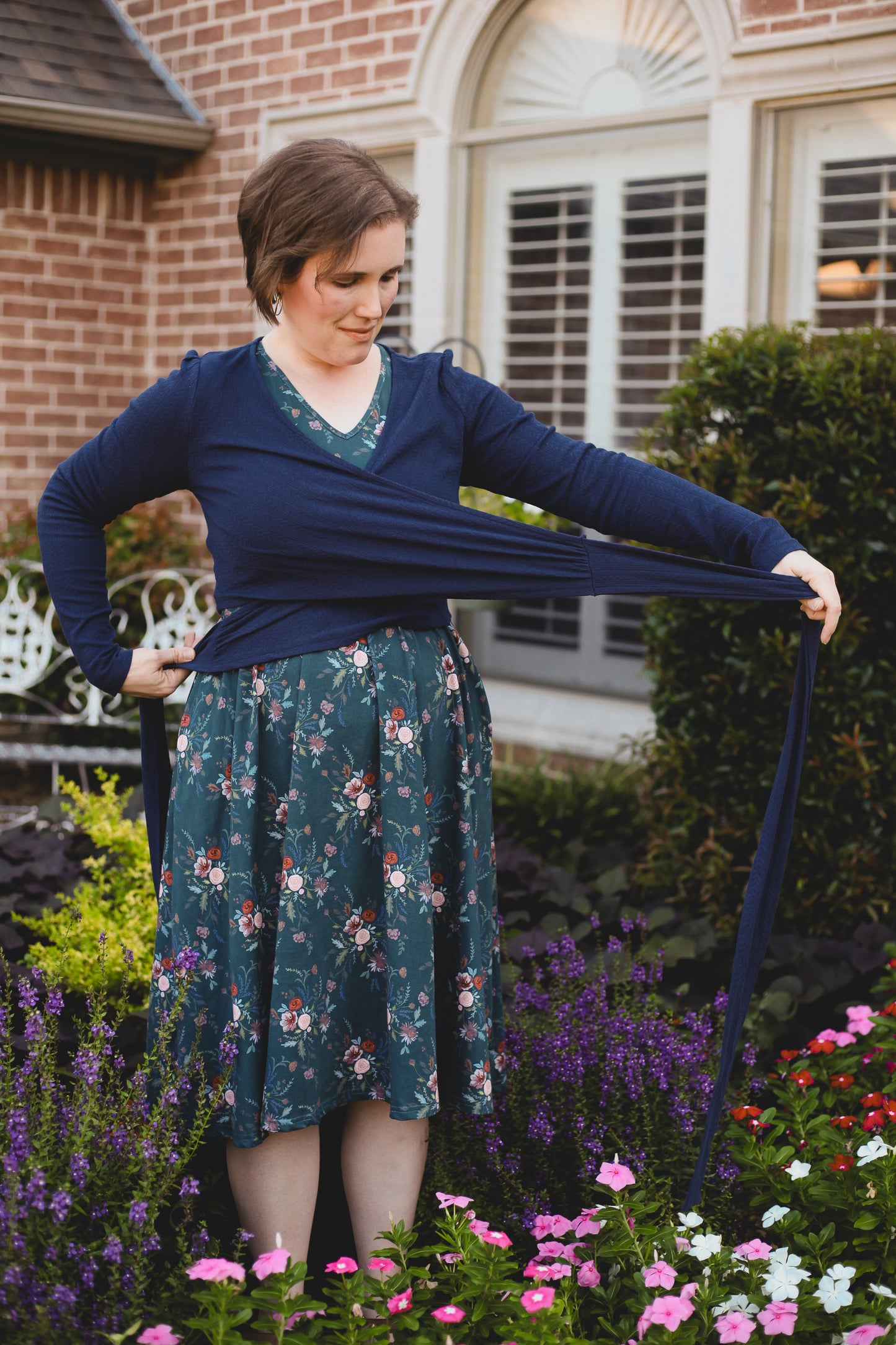 Woman in modest nursing-friendly blue sweater and floral dress