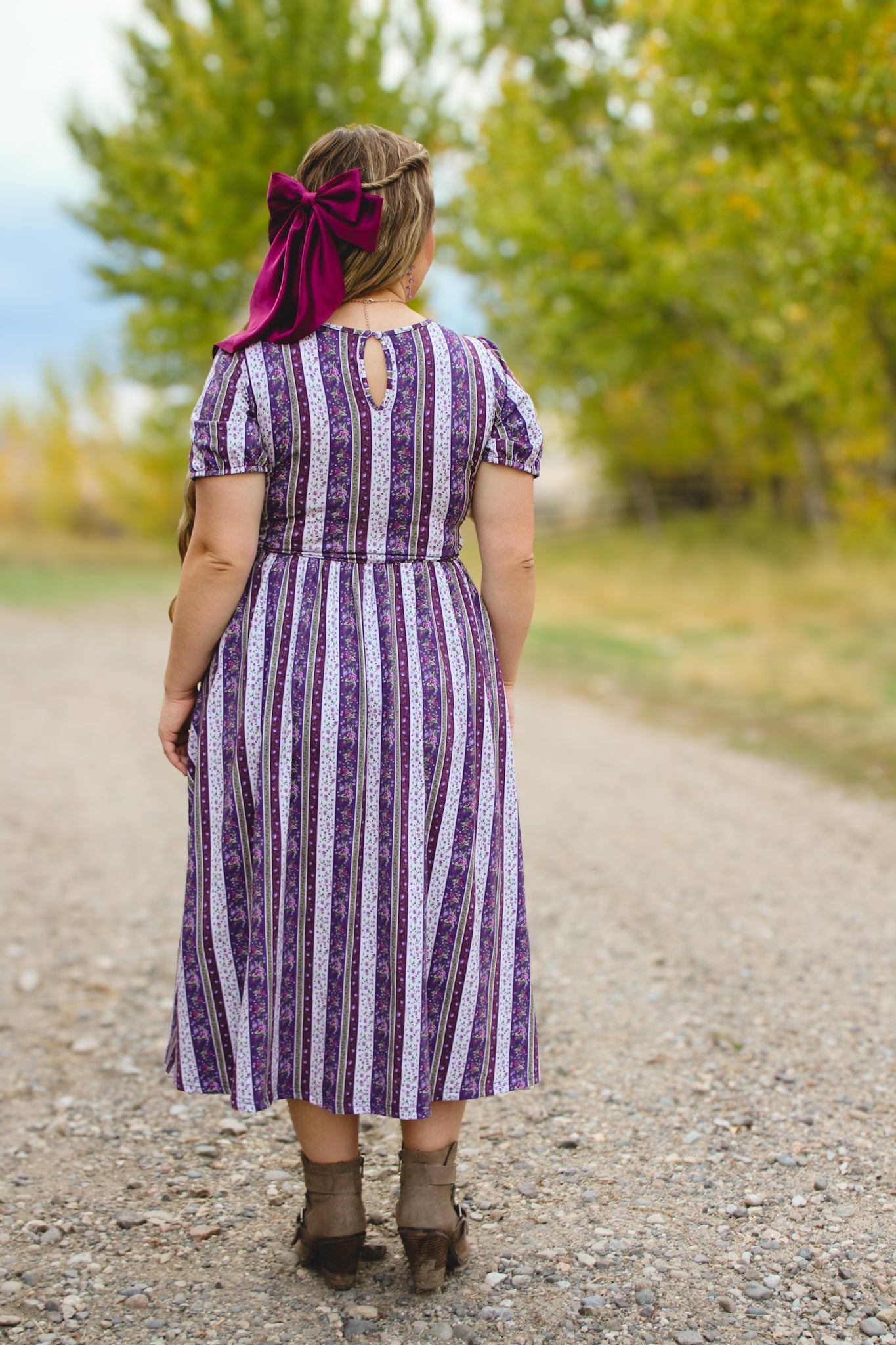 woman wearing a modest nursing purple and white striped dress