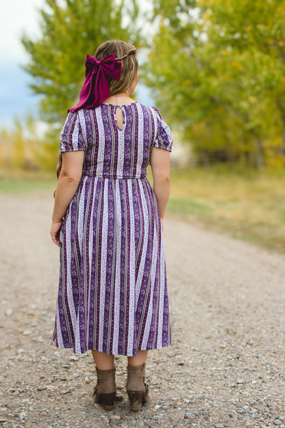 woman wearing a modest nursing purple and white striped dress