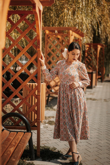 Woman wearing a patterned modest nursing dress
